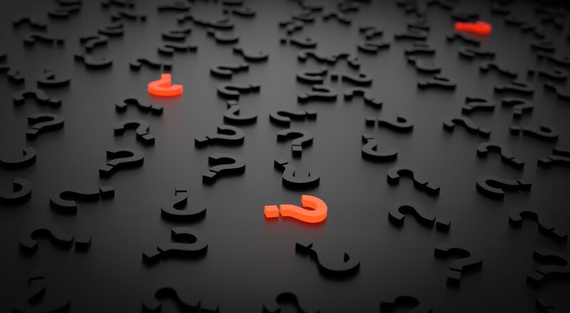 question marks on dark surface