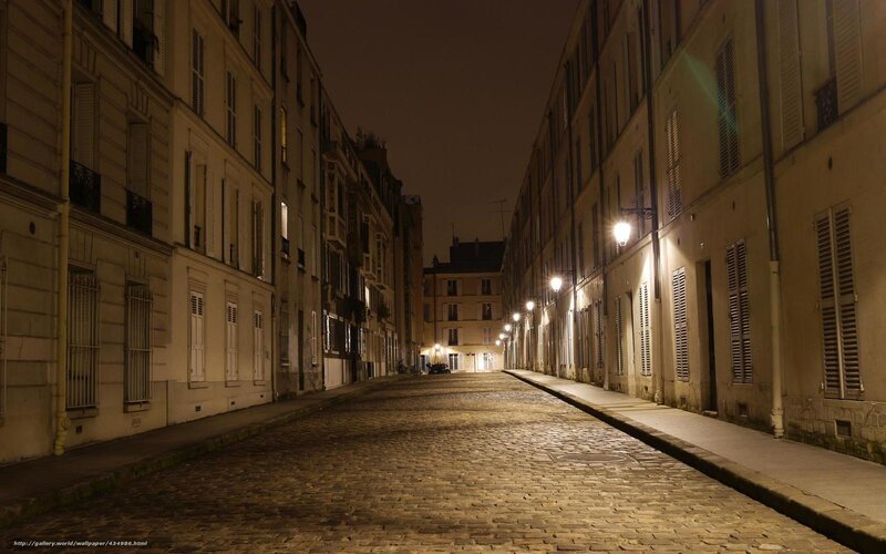 Quiet cobblestone street at night