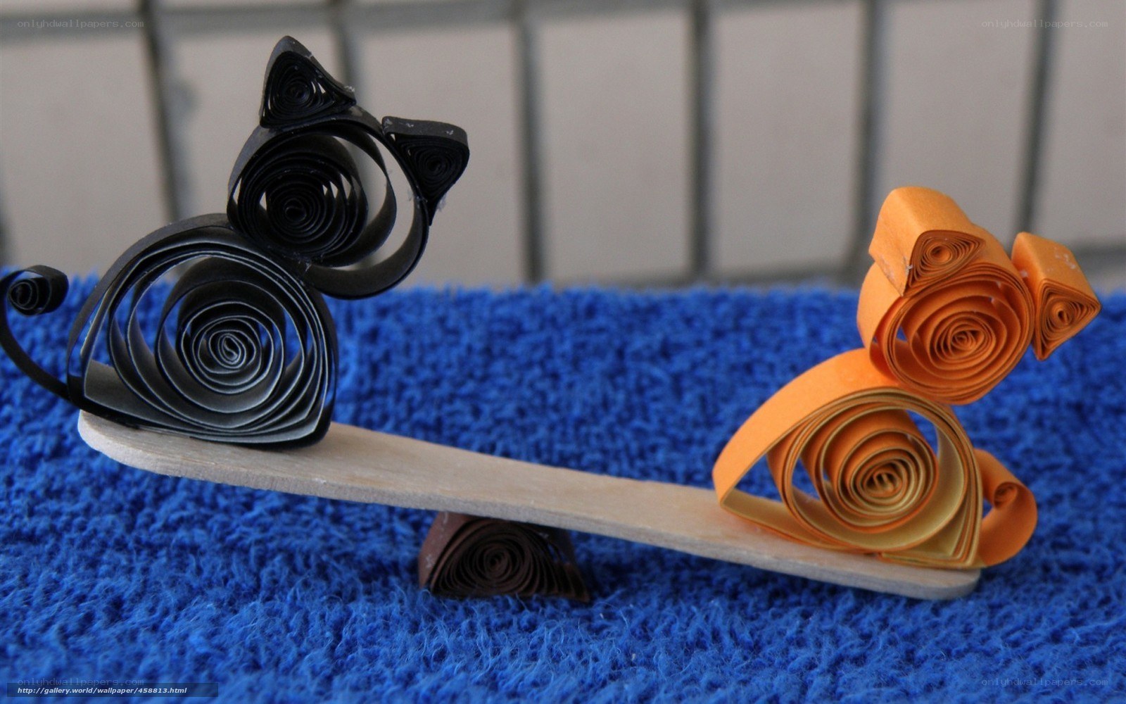 Quilled cats on a seesaw
