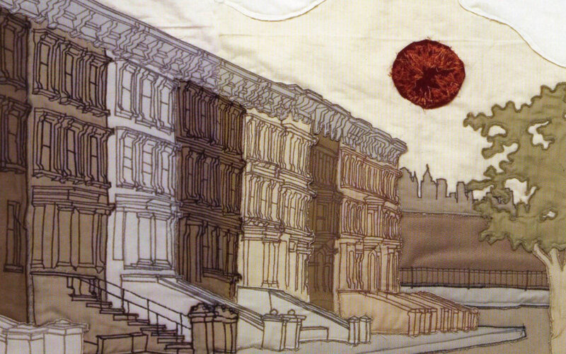 Quilted cityscape with sun