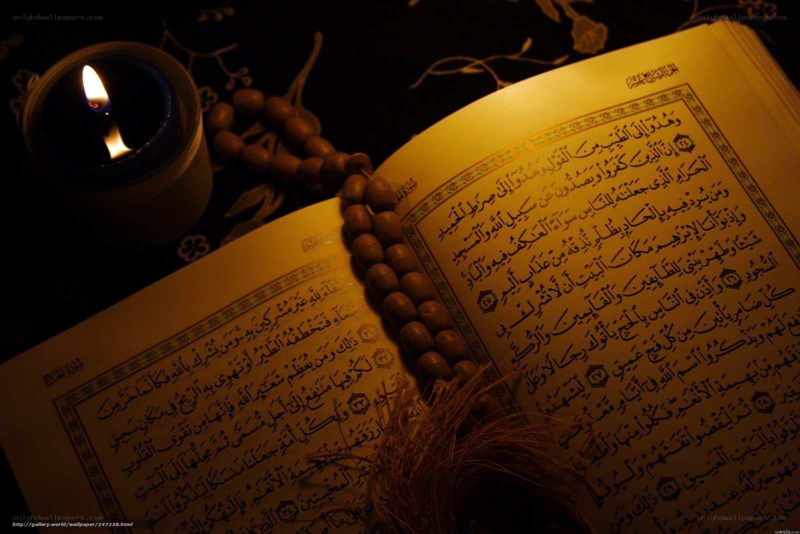 Quran with candle and rosary