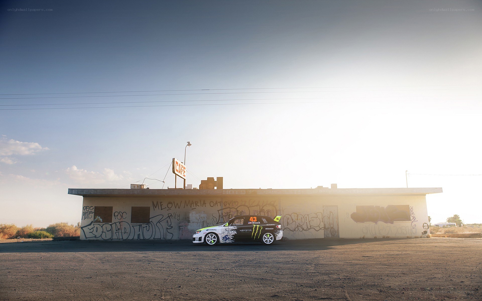 race car at a graffiti-covered cafe