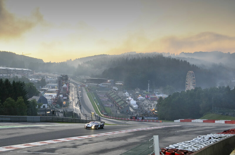 Race car at dawn on a misty track