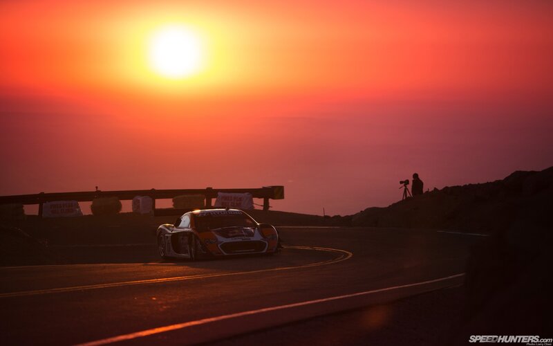 Race car at sunset on a mountain road