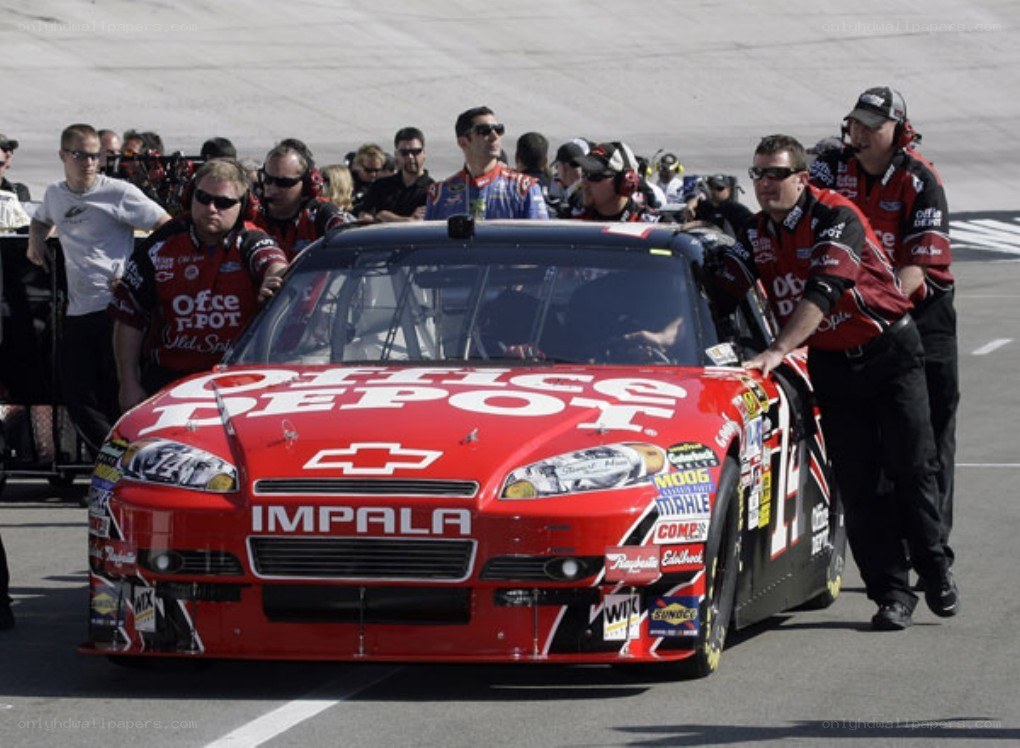 Race car crew pushing vehicle
