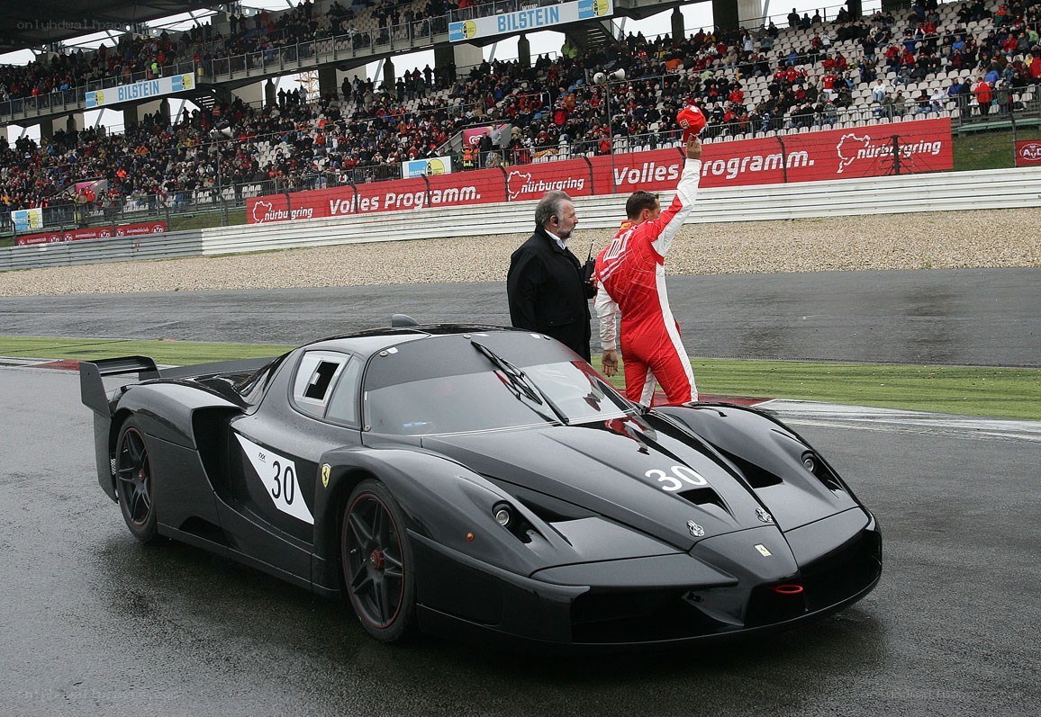 Race car driver celebrating on track