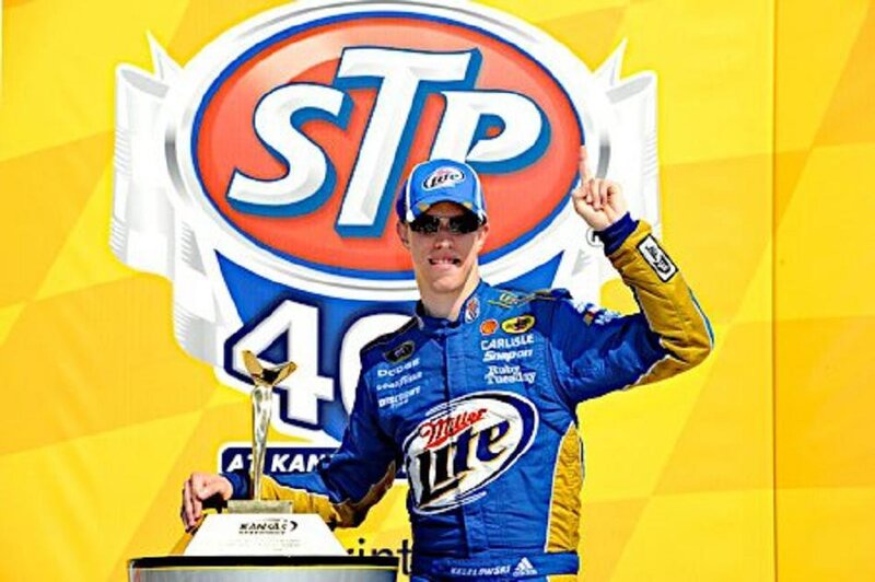Race Car Driver Holding Trophy