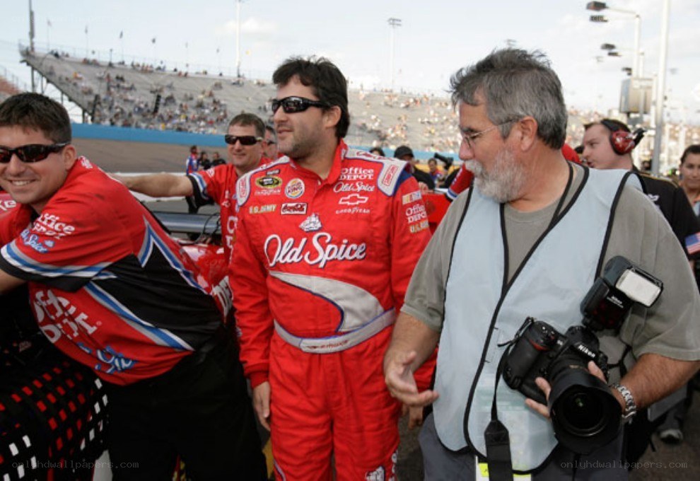 Race car driver with crew at track