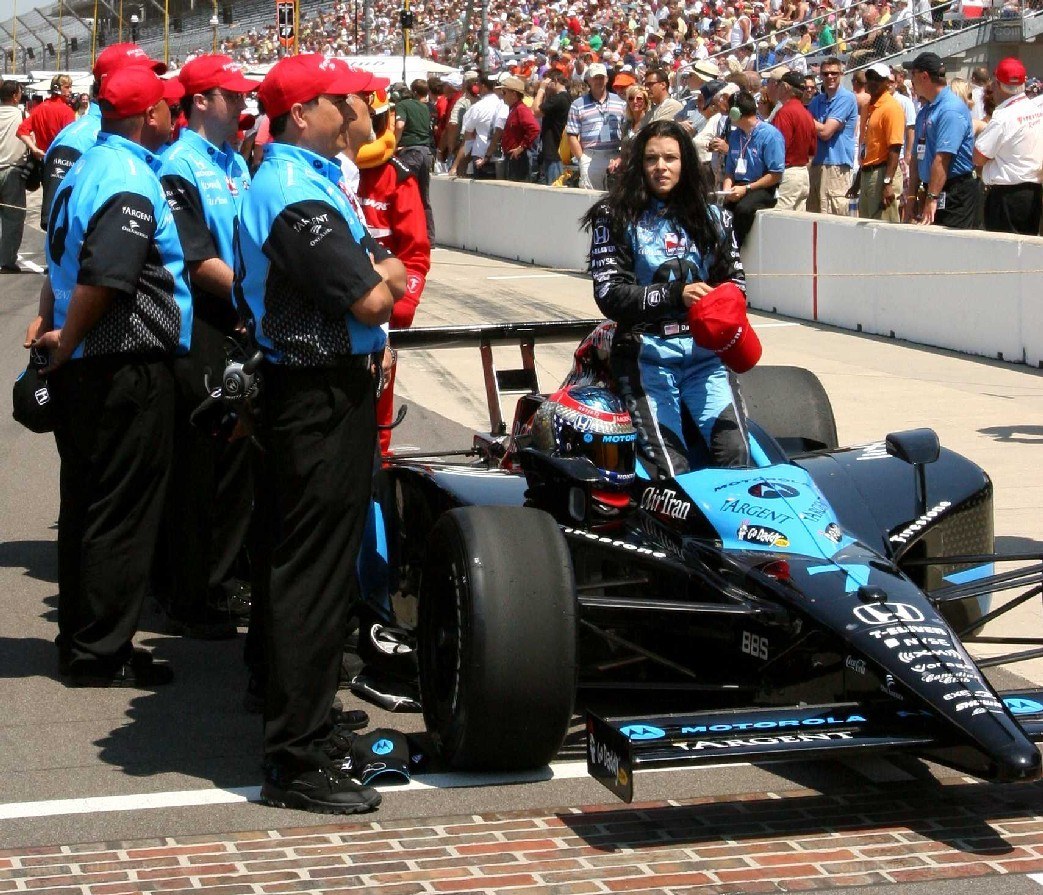 Race car driver with team on track