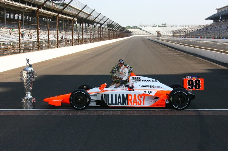 Race car driver with trophy