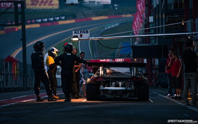 Race car in pit lane at dusk