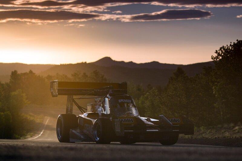 Race car on mountain road at sunset