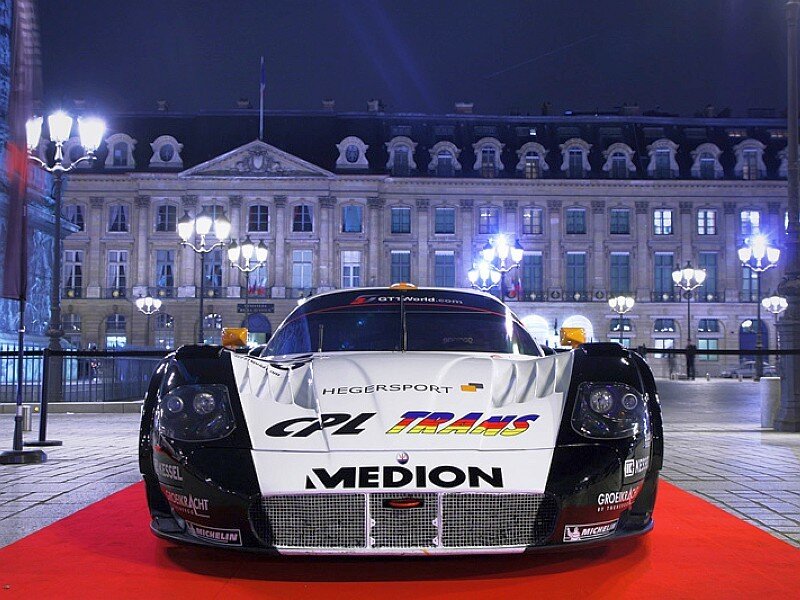 Race car on red carpet at night