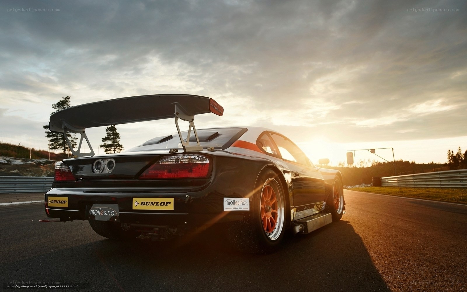 race car on track at sunset