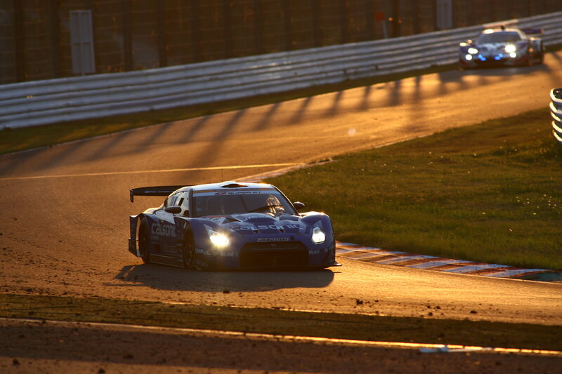 Race car on track at sunset