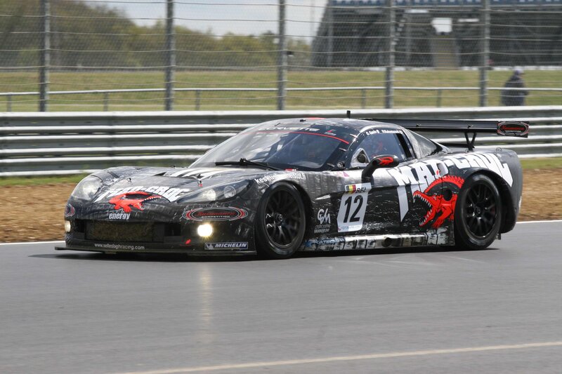 Race Car on Track — Black, Dynamic, Afternoon, Photograph, Fence