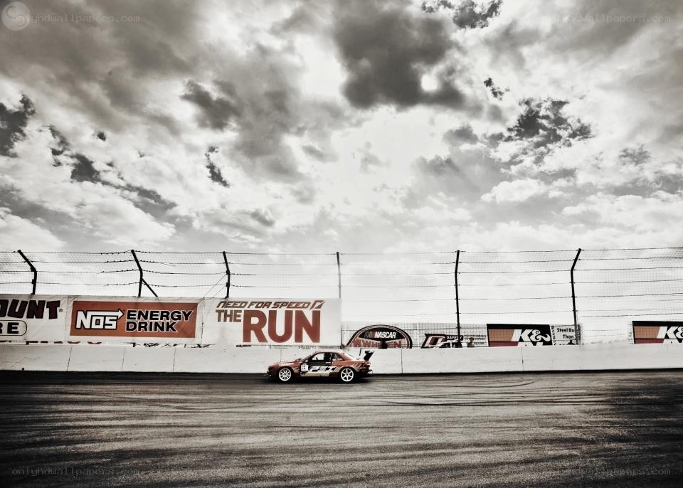 Race car on track under cloudy sky