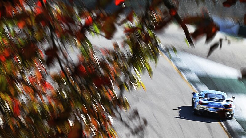 Race car on track with autumn leaves