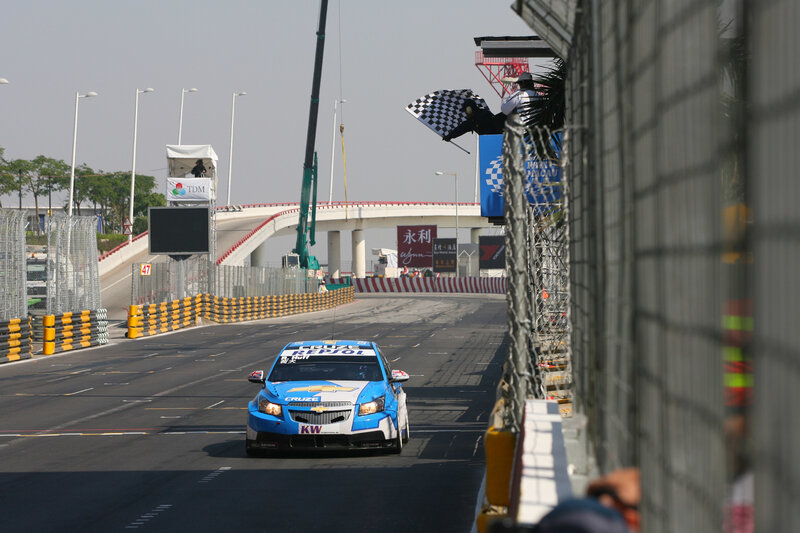 Race car on track with checkered flag