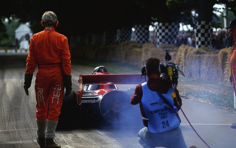 Race car on track with crew