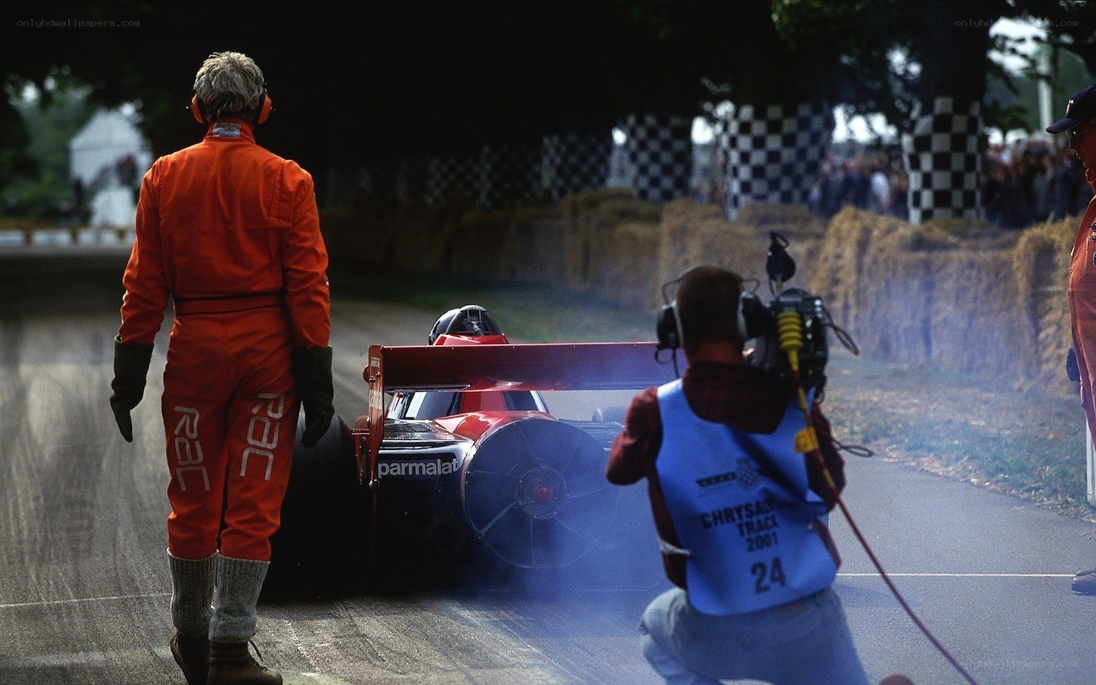 Race car on track with crew