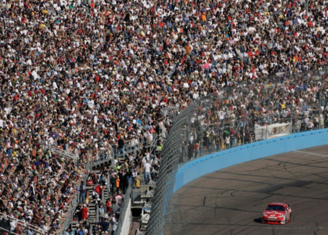 Race car on track with crowd
