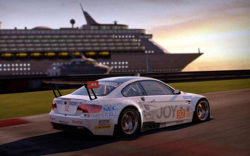 Race car on track with cruise ship