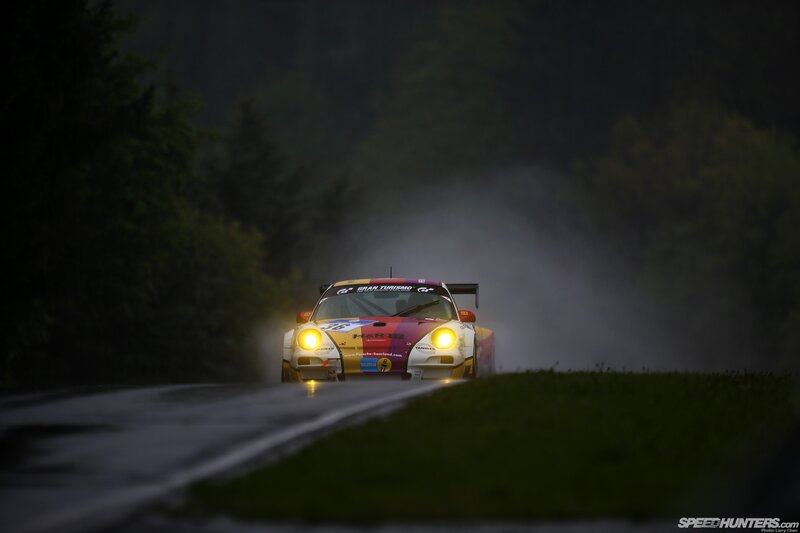 Race car on wet road at night