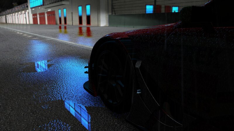 race car on wet track at night