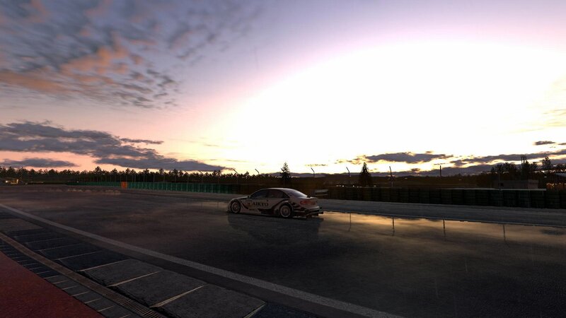 race car on wet track at sunset