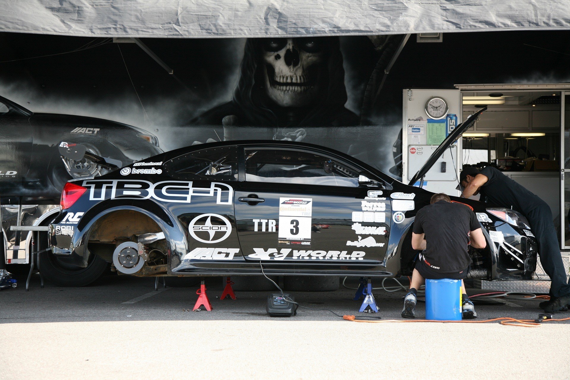 Race car pit stop with skull mural