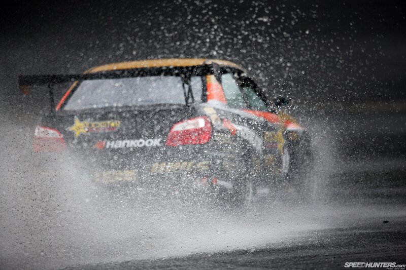Race car splashing water on track