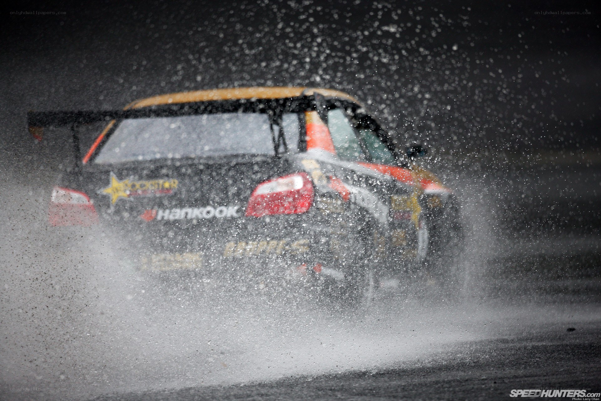 Race car splashing water on track