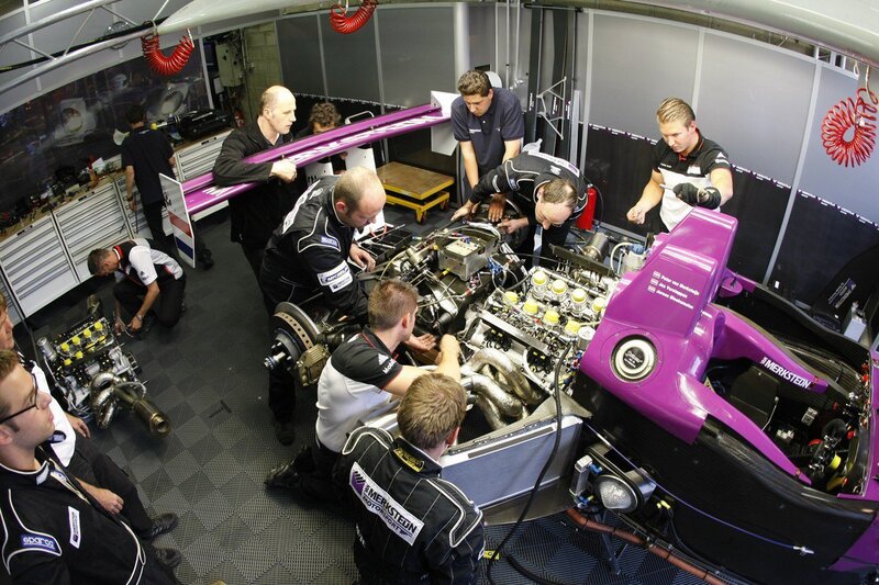 Race car team working in garage