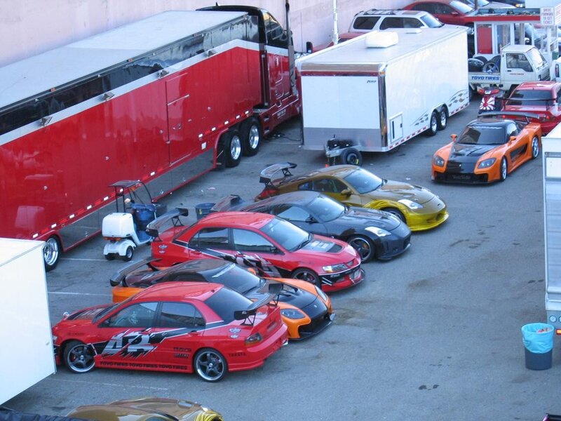 race cars and trailers at a track