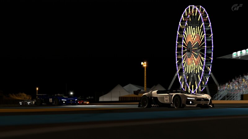 Race cars at night with ferris wheel