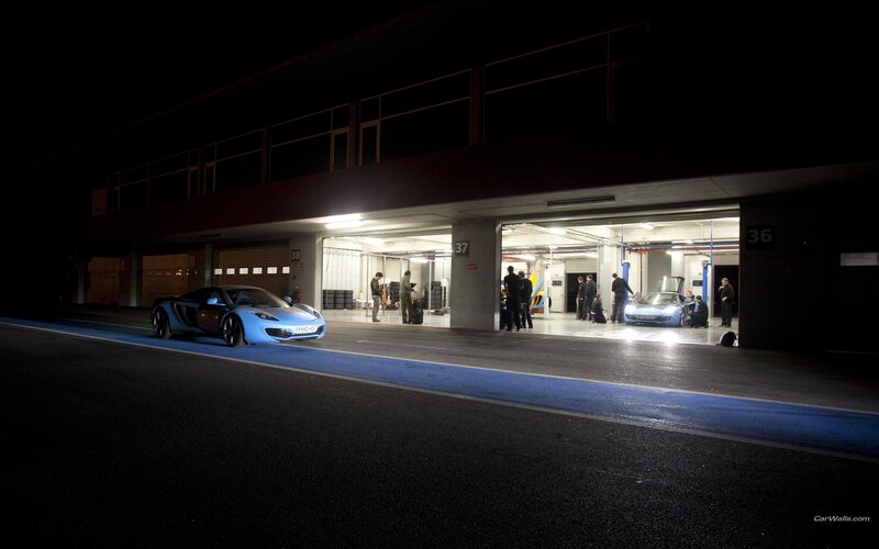 Race cars in pit lane at night