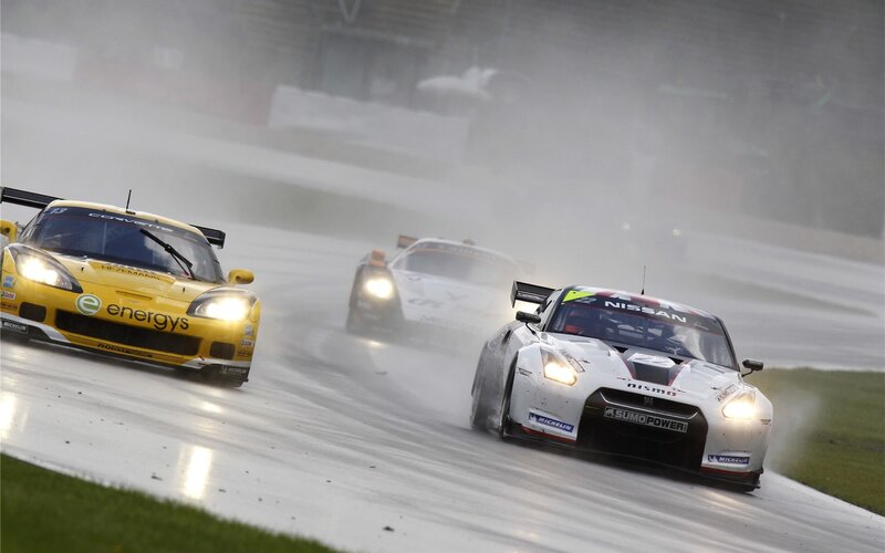 Race cars in rain on track