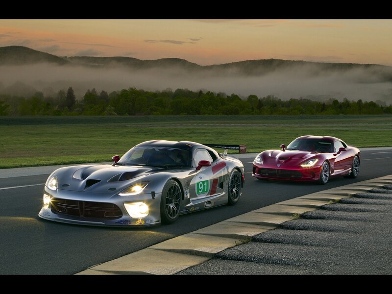 Race cars on a track at dawn