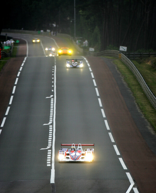 Race cars on a track at night