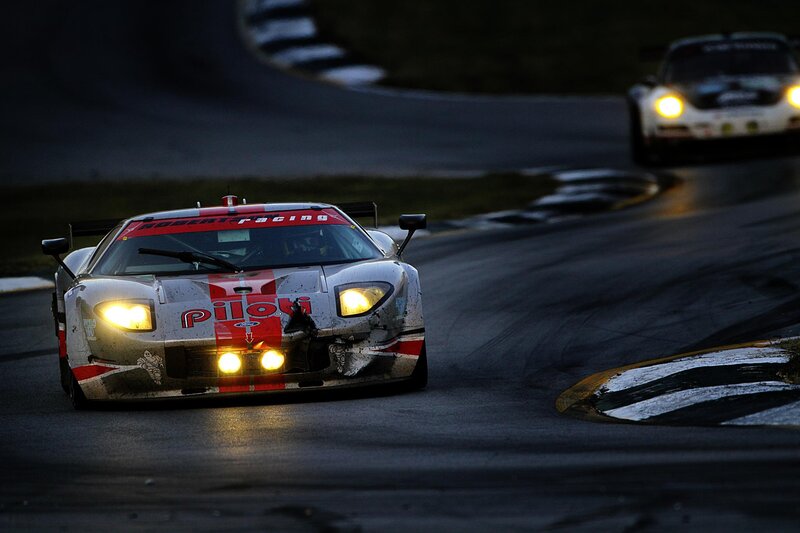 Race cars on a track at night