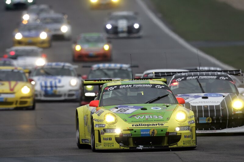 Race cars on a track at night