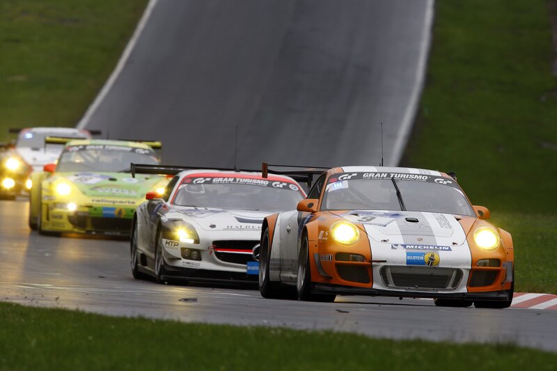Race cars on a track at night