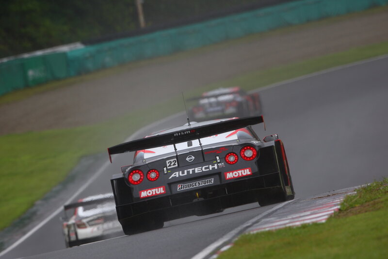 Race cars on a wet track