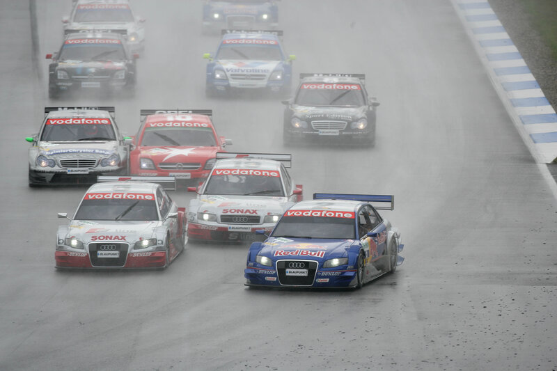 Race cars on a wet track