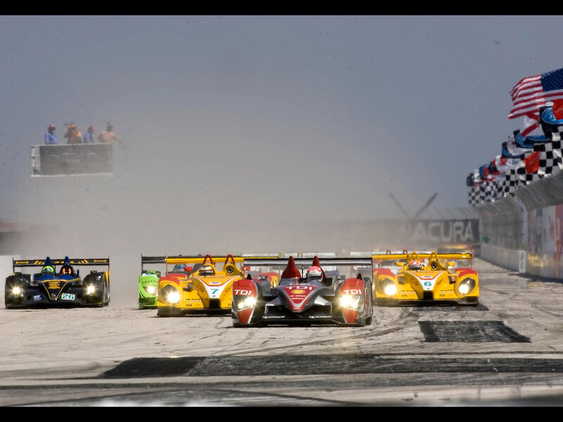 Race cars on a wet track