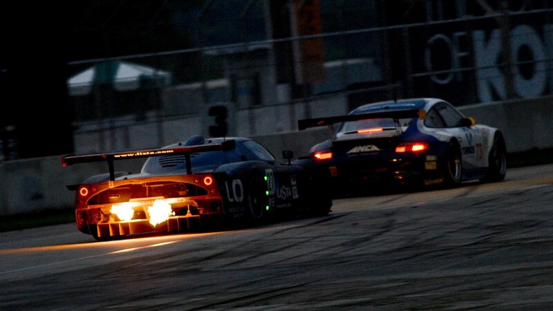 Race cars on track at night