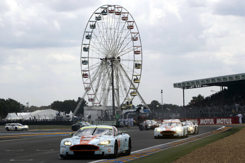 Race cars on track with ferris wheel
