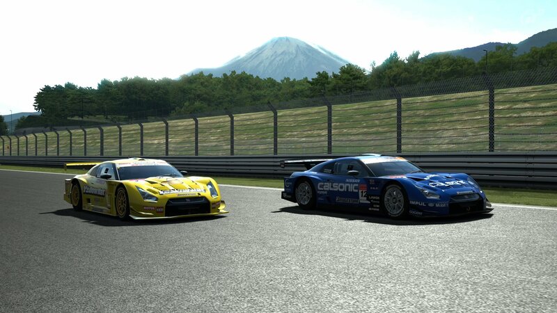Race cars on track with mountain