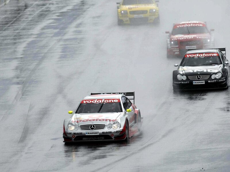 Race cars on wet track